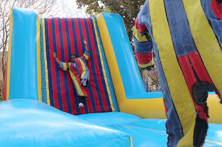 First-year acting graduate student Oluchi Nwokocha, 23, descends from a Velcro wall on the North Lawn Tuesday afternoon. The wall was part of UF Engineers Week’s Field Day Extravaganza.