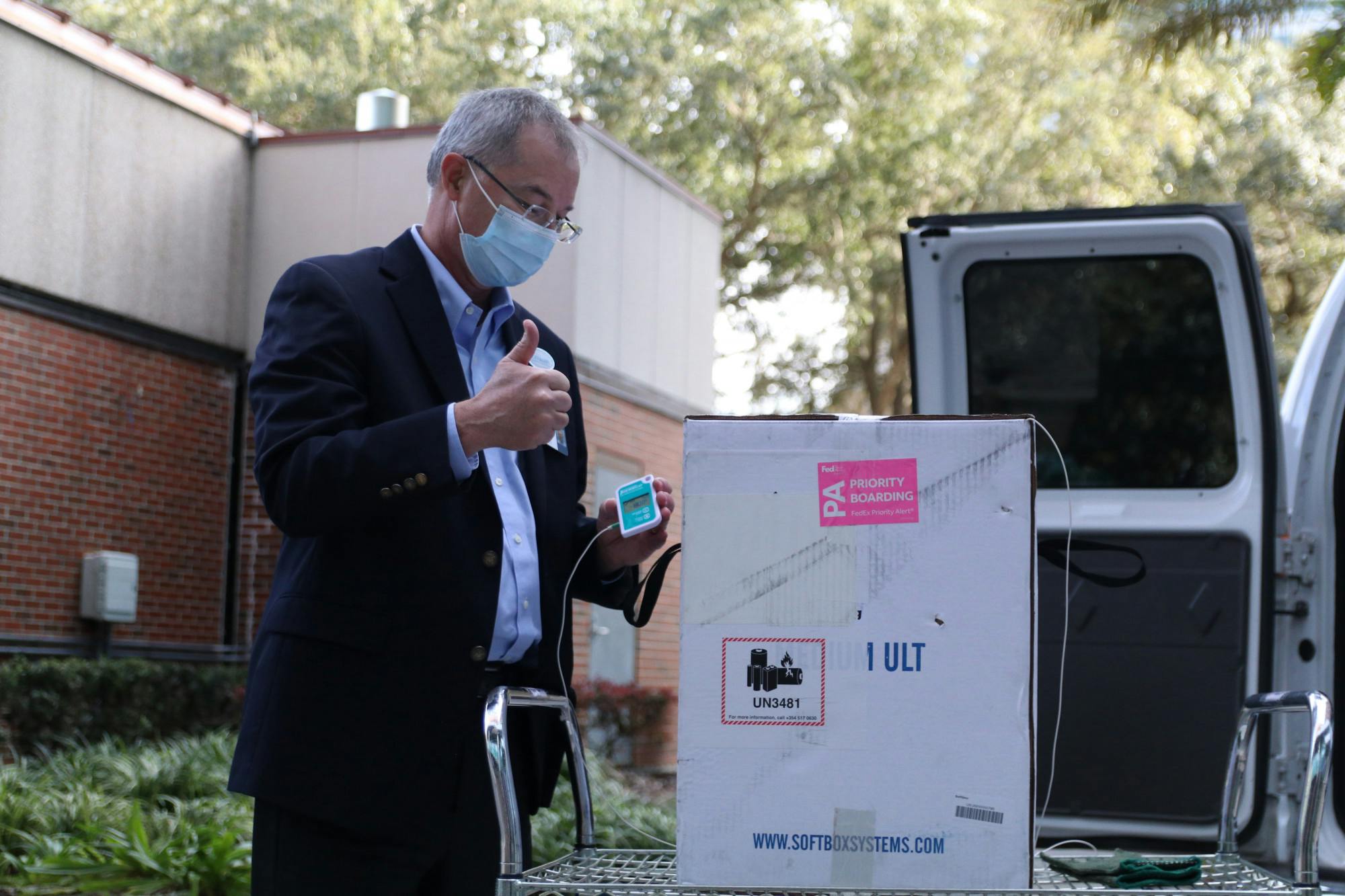 Thomas Johns, Director of Pharmacy Services at UF, gives a thumbs up after displaying the thermometer to the press. The Pfizer-BioNTech COVID-19 vaccine has to be stored at ultracold temperatures.
