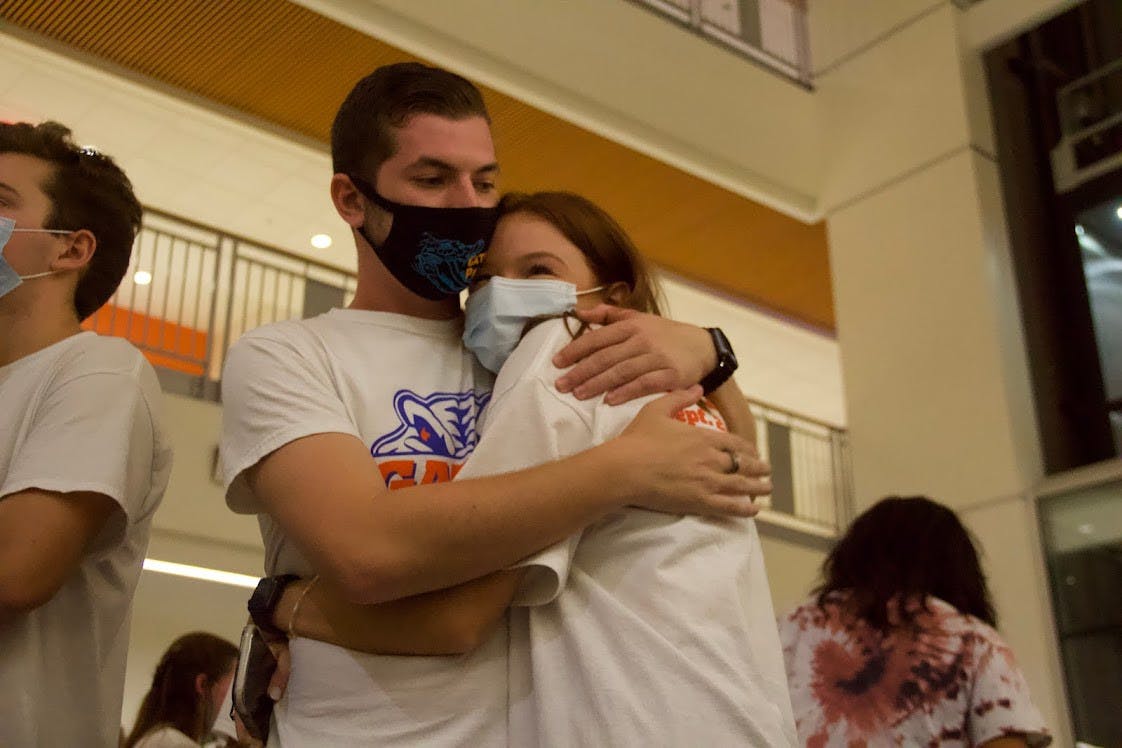 Noah Fineberg (left) and Annabelle Groux (right) embrace while waiting for the Student Government Senate election results at the watch party held at the Reitz Union on Wednesday, Sept. 29, 2021. The two were elected senators for District A. 