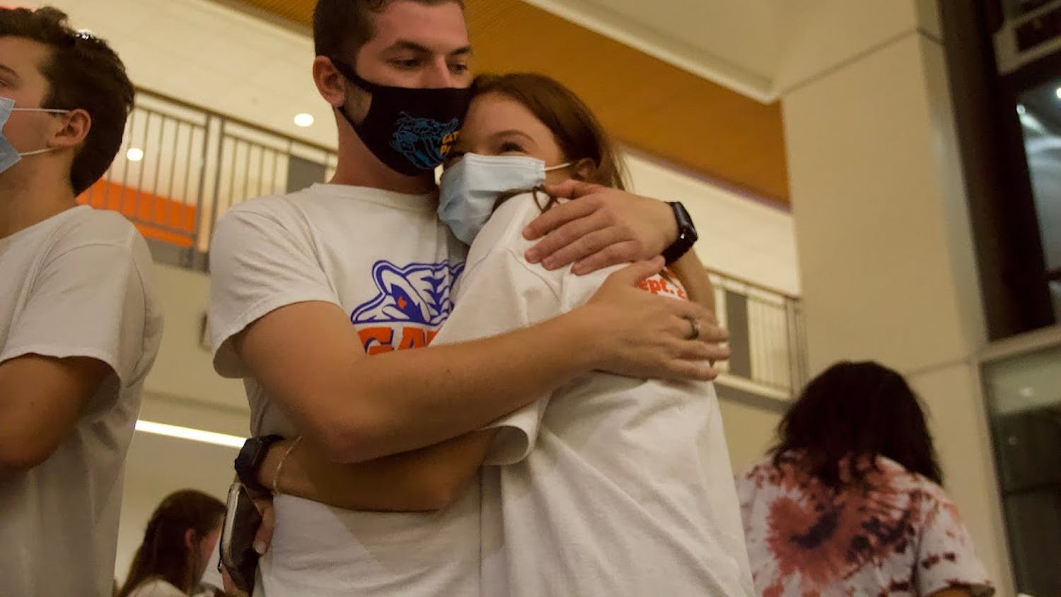 Noah Fineberg (left) and Annabelle Groux (right) embrace while waiting for the Student Government Senate election results at the watch party held at the Reitz Union on Wednesday, Sept. 29, 2021. The two were elected senators for District A.
