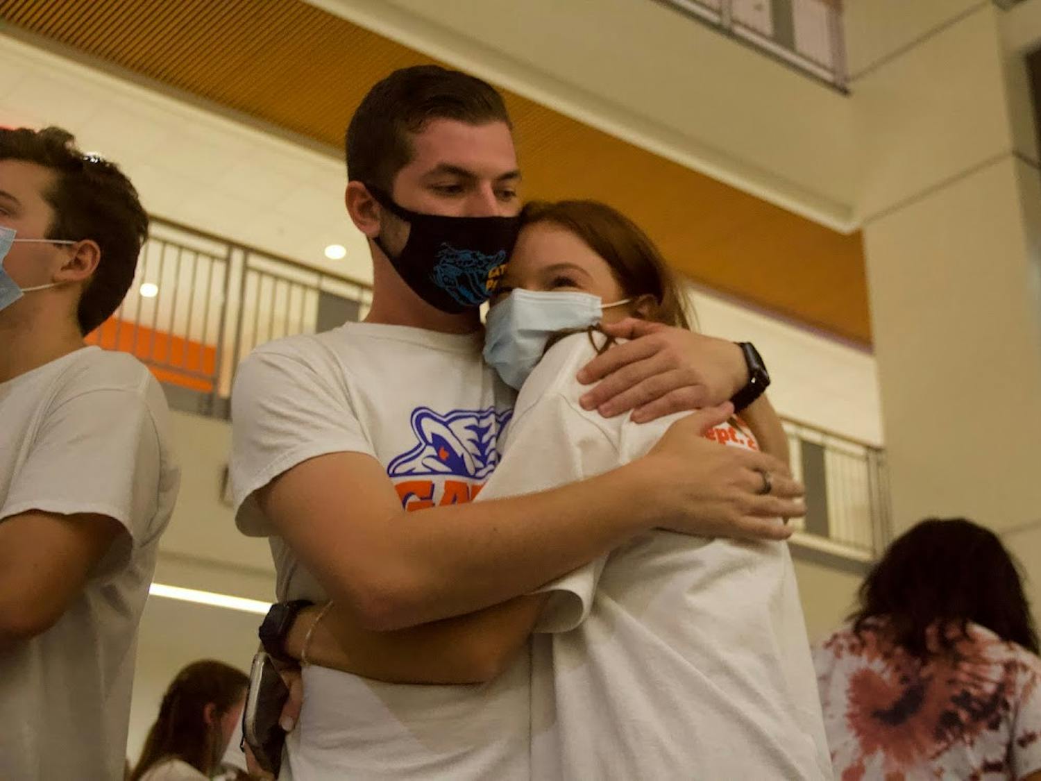 Noah Fineberg (left) and Annabelle Groux (right) embrace while waiting for the Student Government Senate election results at the watch party held at the Reitz Union on Wednesday, Sept. 29, 2021. The two were elected senators for District A. 