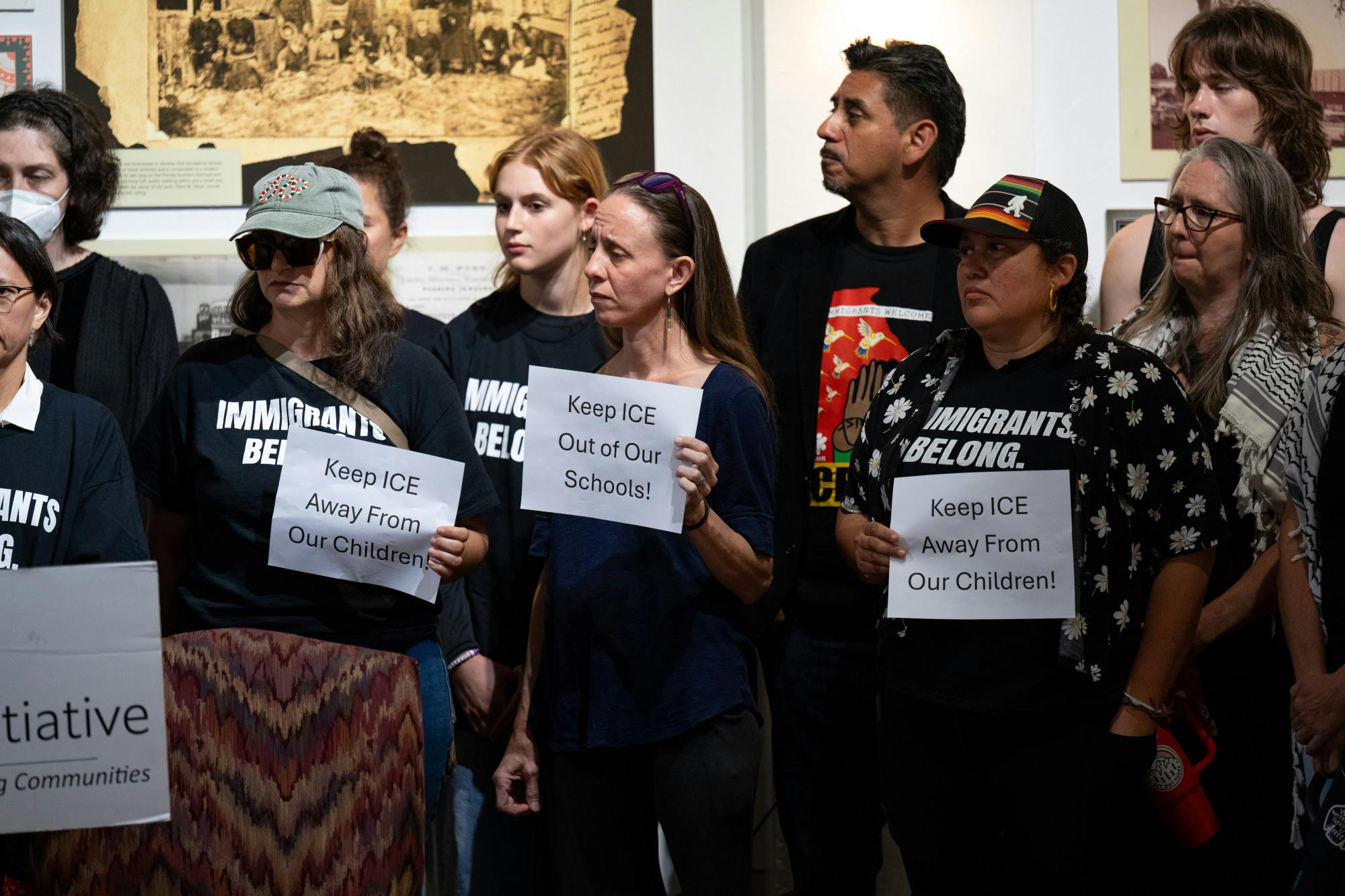 Alachua County residents and members of the Gainesville Immigrant Neighborhood Inclusion Initiative hold signs that read, “Keep ICE Away From Our Children!” during a press conference before an ICE protest at an Alachua County Public Schools board meeting on Tuesday, April 15, 2025, in Gainesville, Fla.