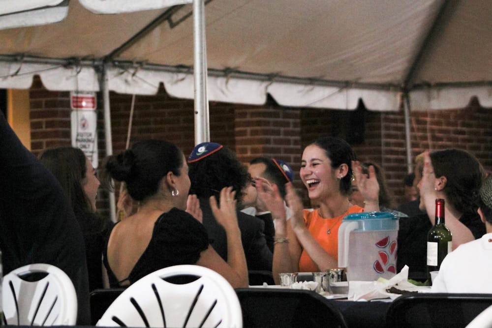 <p>Students sing and clap after dinner during the Passover Seder﻿ at Lubavitch Chabad Jewish Student Center Wednesday, April 5, 2023.</p>