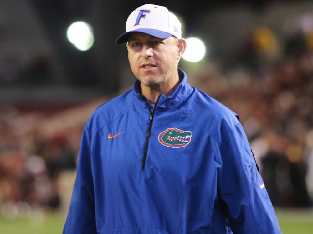 <p>Brent Pease watches players warm up prior to Florida’s 19-14 loss to South Carolina on Saturday at Williams-Brice Stadium in Columbia, S.C. Using a new-look attack, the Gators ran for 200 yards — 169 coming in the first half — against the Gamecocks.</p>