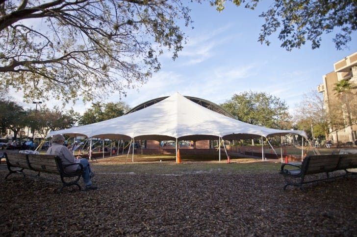 Patrick O’Connor, 63, searches a trucking pamphlet for a job as a hired driver on Bo Diddley Community Plaza Sunday afternoon. “I used to go ice skating when I was a little kid,” he said.
