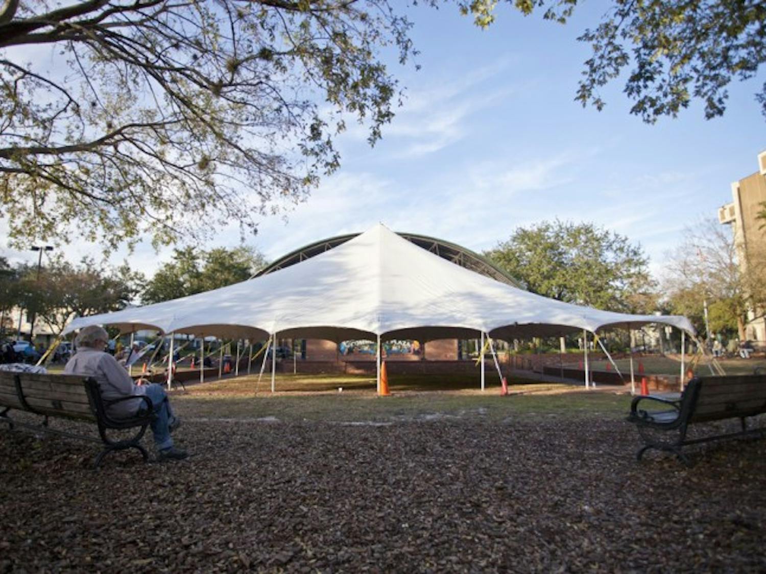 Patrick O’Connor, 63, searches a trucking pamphlet for a job as a hired driver on Bo Diddley Community Plaza Sunday afternoon. “I used to go ice skating when I was a little kid,” he said.