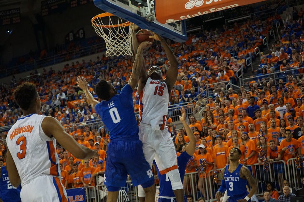 <p>UF center John Egbunu goes for a layup over Kentucky's Marcus Lee during Florida's 88-79 loss on March 1, 2016, in the O'Connell Center.</p>