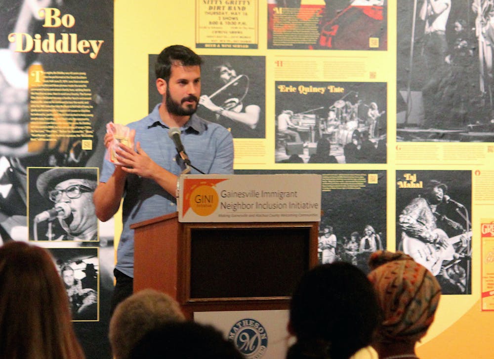 Board member of the Gainesville Immigrant Neighbor Inclusion Initiative Ethan Maia de Needell speaks at the GINI Anniversary celebration at the Matheson History Museum on Friday, Sept. 8, 2023. Ethan Maia de Needell, miembro de la junta de Inclusión de Vecinos Inmigrantes de Gainesville [Gainesville Immigrant Neighbor Inclusion], habla en la celebración del aniversario de GINI en el Museo de Historia de Matheson el viernes 8 de septiembre de 2023.