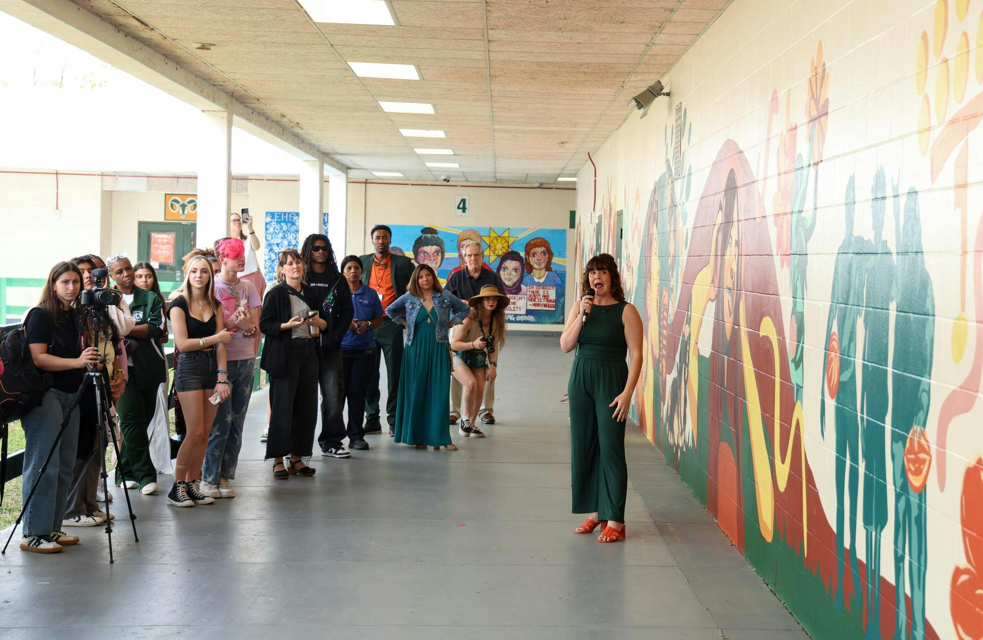 Jenna Horner presents her mural to the crowd at Eastside High School, Tuesday, March 31, 2026, in Gainesville, Fla.
