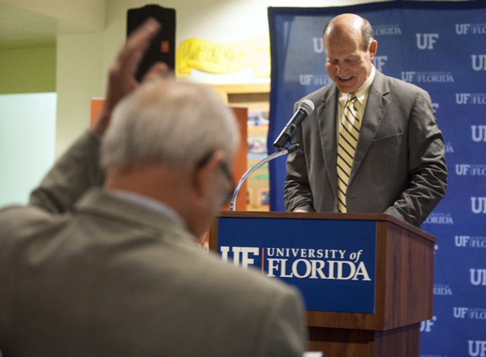 <p>UF President Bernie Machen acknowledges his introduction by Dave Kratzer, vice president for student affairs, at an award ceremony Wednesday morning.</p>
<div>&nbsp;</div>