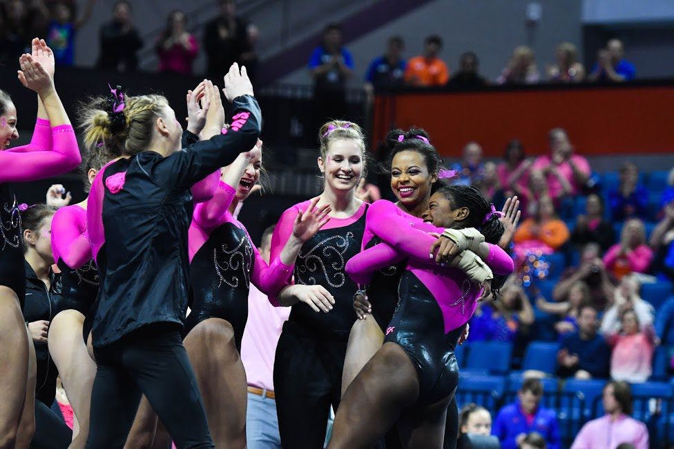 UF gymnast Kennedy Baker hugs teammate Alicia Boren and celebrates with teammates during Florida's win over Auburn on Friday night in the O'Connell Center.&nbsp;