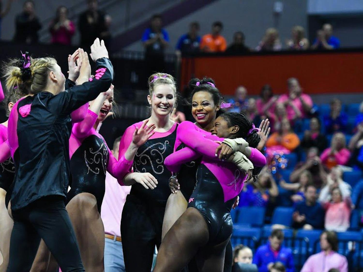 UF gymnast Kennedy Baker hugs teammate Alicia Boren and celebrates with teammates during Florida's win over Auburn on Friday night in the O'Connell Center.&nbsp;