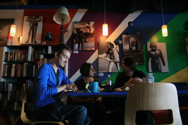 Richard Williams, Kati Ricci and Joshua Degen eat at Flashbacks Cafe, a new grab-'n'-go coffee shop, juice bar and bakery located at 211 W University Ave., on Monday.