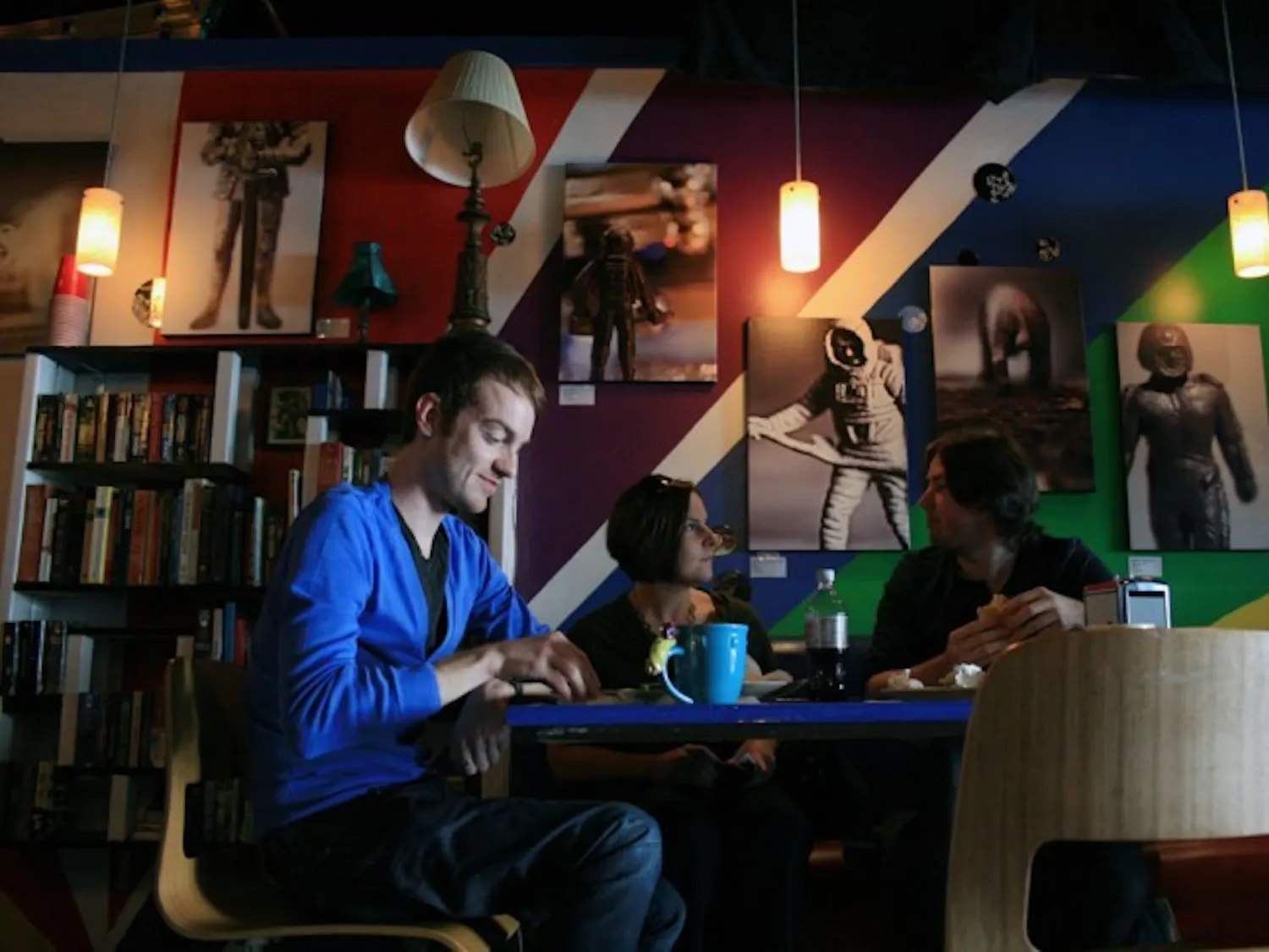 Richard Williams, Kati Ricci and Joshua Degen eat at Flashbacks Cafe, a new grab-'n'-go coffee shop, juice bar and bakery located at 211 W University Ave., on Monday.