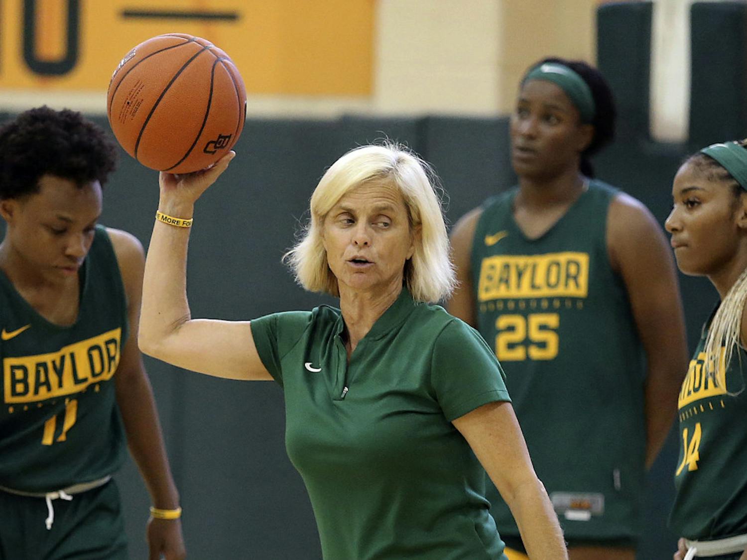 FILE - In this Sept. 30, 2019, file photo, Baylor women's coach Kim Mulkey, center, talks with players during the NCAA college basketball team's practice in Waco, Texas. The NCAA Division I Council on Wednesday, June 17, 2020, approved a plan to allow college basketball players to start working with their coaches for the first time since the pandemic wiped out March Madness. The summer access period for men's and women's players will begin July 20. (Jerry Larson/Waco Tribune-Herald via AP, File)
