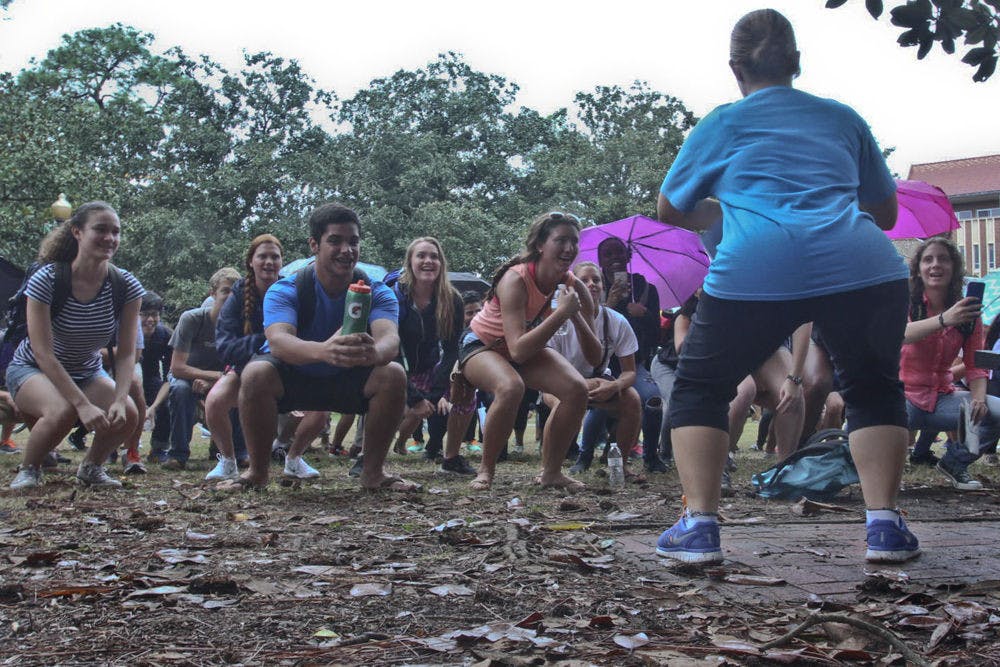 Jodi Bieluch (right), a 20-year-old psychology junior, leads a group of about 80 students to squat in an attempt to break a world record on the Plaza of the Americas on Nov. 19, 2015. Gators for UNICEF hosted the squat to inform students about the 2.5 million people around the world who don’t have access to restrooms.