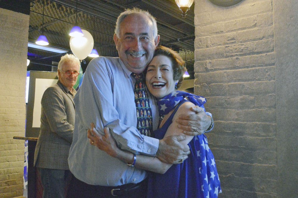 Harvey Budd and his wife, Ilene, celebrate Budd’s victory over Jay Curtis in the race for the at-large commissioner seat Tuesday night in a banquet room in the Hippodrome Theater.