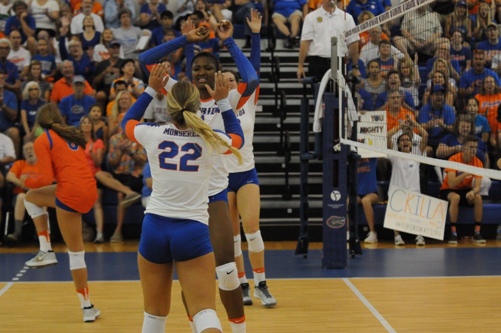 Allie Monserez (22) celebrates with teammate Rhamat Alhassan during Florida's Sept. 17, 2016, win over Marshall in the Lemerand Center. 