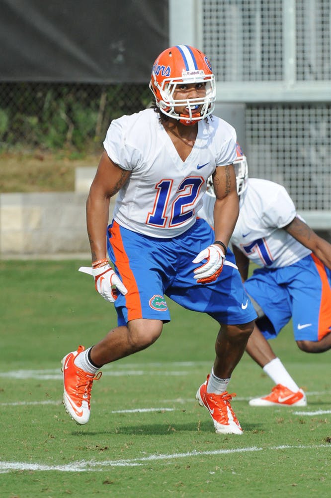 Antonio Morrison runs through drills during a spring practice in 2012. Will Muschamp reduced Morrison’s suspension from two games to one Monday.