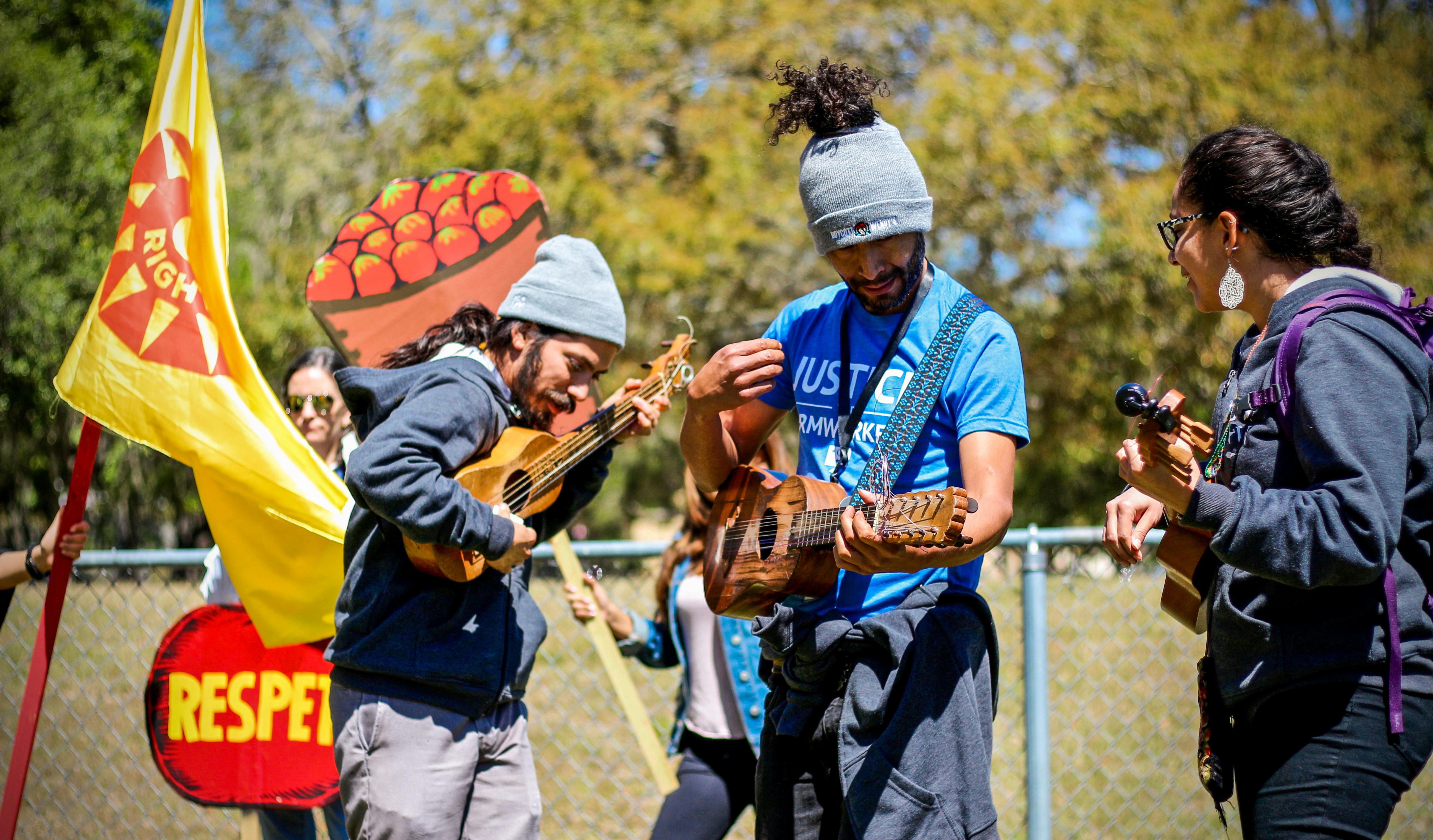 From left: Luis Sarmiento, 30, Pedro López, 39, and Natali Rodriguez, 27, come together in alliance with the Coalition of Immokalee Workers to boycott Wendy's while playing the ukulele on Norman Field on Thursday afternoon. 
