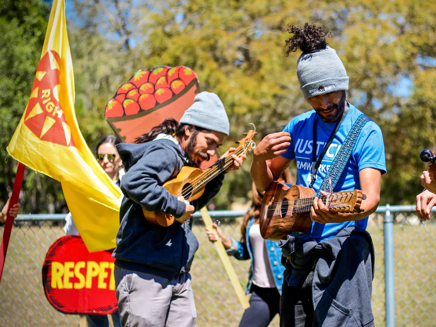 From left: Luis Sarmiento, 30, Pedro López, 39, and Natali Rodriguez, 27, come together in alliance with the Coalition of Immokalee Workers to boycott Wendy's while playing the ukulele on Norman Field on Thursday afternoon.