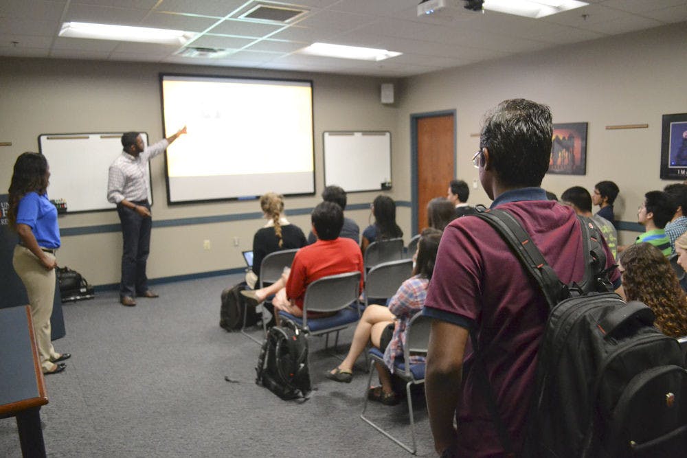 <p>Rohan Pansare (right), a 24-year-old UF computer science masters student, walks into a LinkedIn workshop at the University of Florida Career Resource Center Sept. 21, 2015. The workshop was held for students in preparation for the Career Showcase. Students will be able to receive free headshots for their profile at the CRC’s LinkedIn booth during the Career Showcase next week.</p>