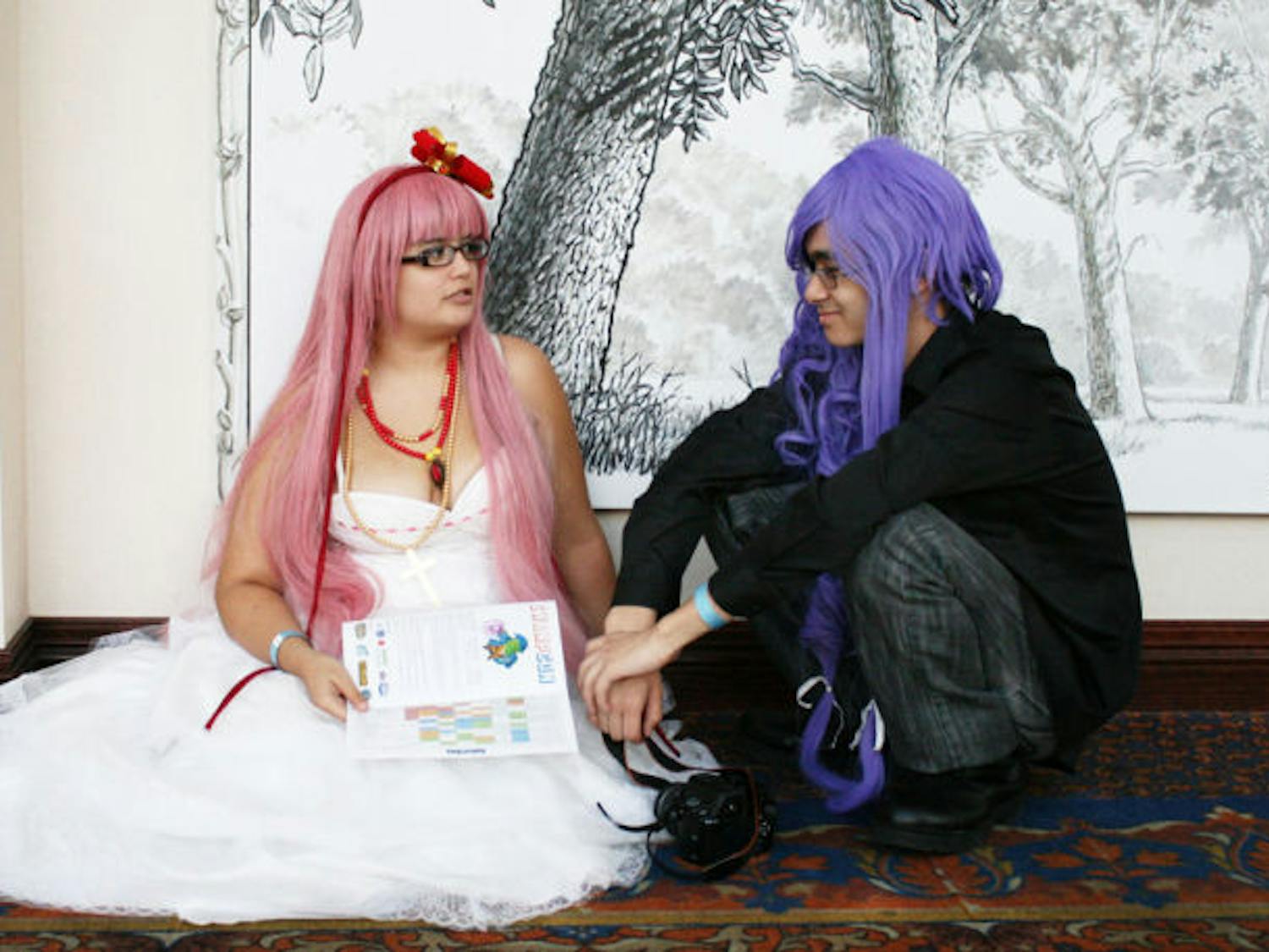 Amy Bradley, left, a 23-year-old UF alumna, and James Hamlin, right, a 19-year-old engineering and Japanese freshman, dressed up as Vocaloids during the second-annual SwampCon, a multigenre convention, this weekend at the Reitz Union.
