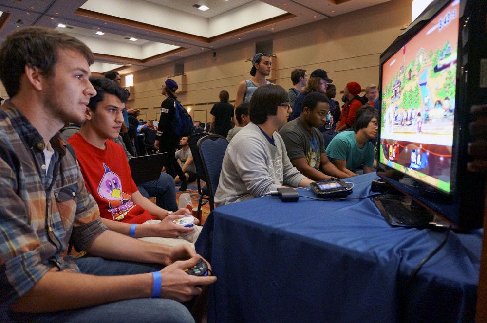 <p>Jacob Goodling (left), a 20-year-old UF mathematics sophomore, competes against Esaias “Leaf” Delfin, 18, in a Super Smash Bros. for Wii U tournament at GatorLAN on Saturday.</p>