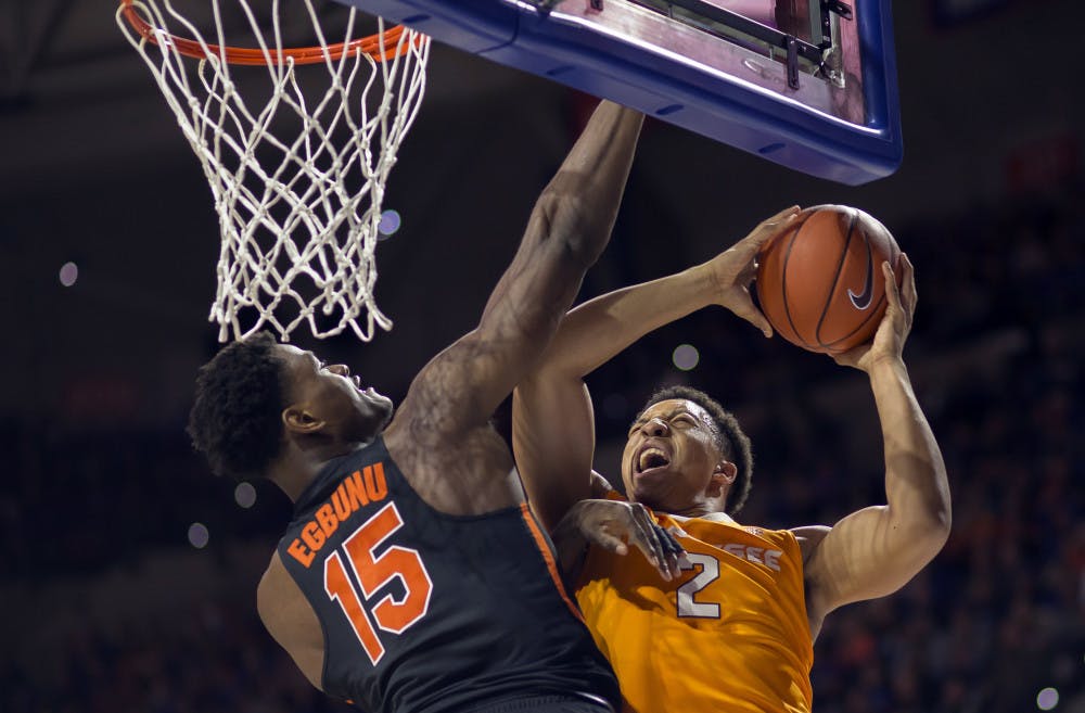 Florida center John Egbunu (15) fouls Tennessee forward Grant Williams (2) on this shot attempt during the first half of an NCAA college basketball game in Gainesville, Fla., Saturday, Jan. 7, 2017. (AP Photo/Ron Irby)
