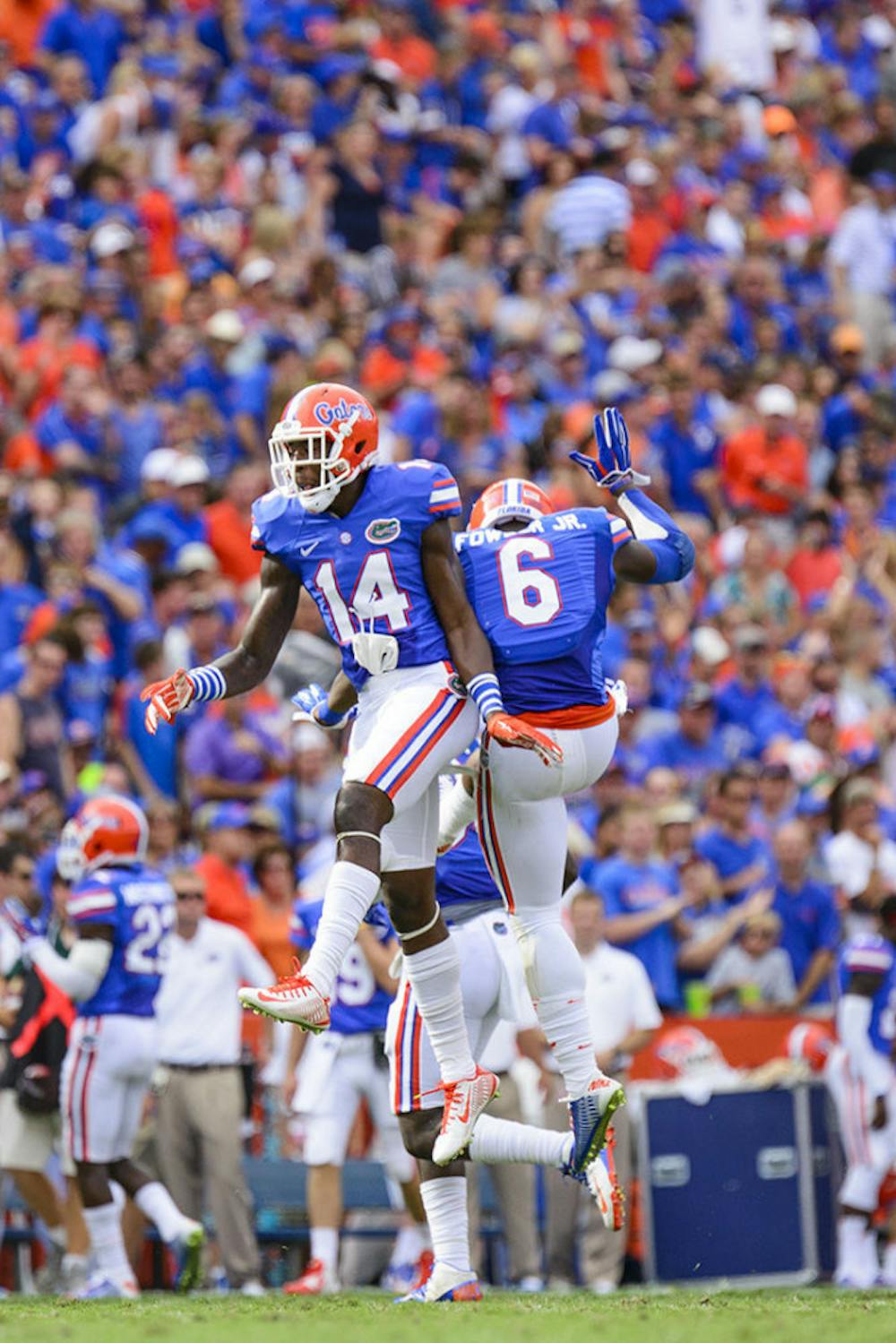 <p><span>Alex McCalister and Dante Fowler Jr. celebrate an Eagles turnover during the Florida's 65-0 win against Eastern Michigan on Saturday at Ben Hill Griffin Stadium.</span></p>