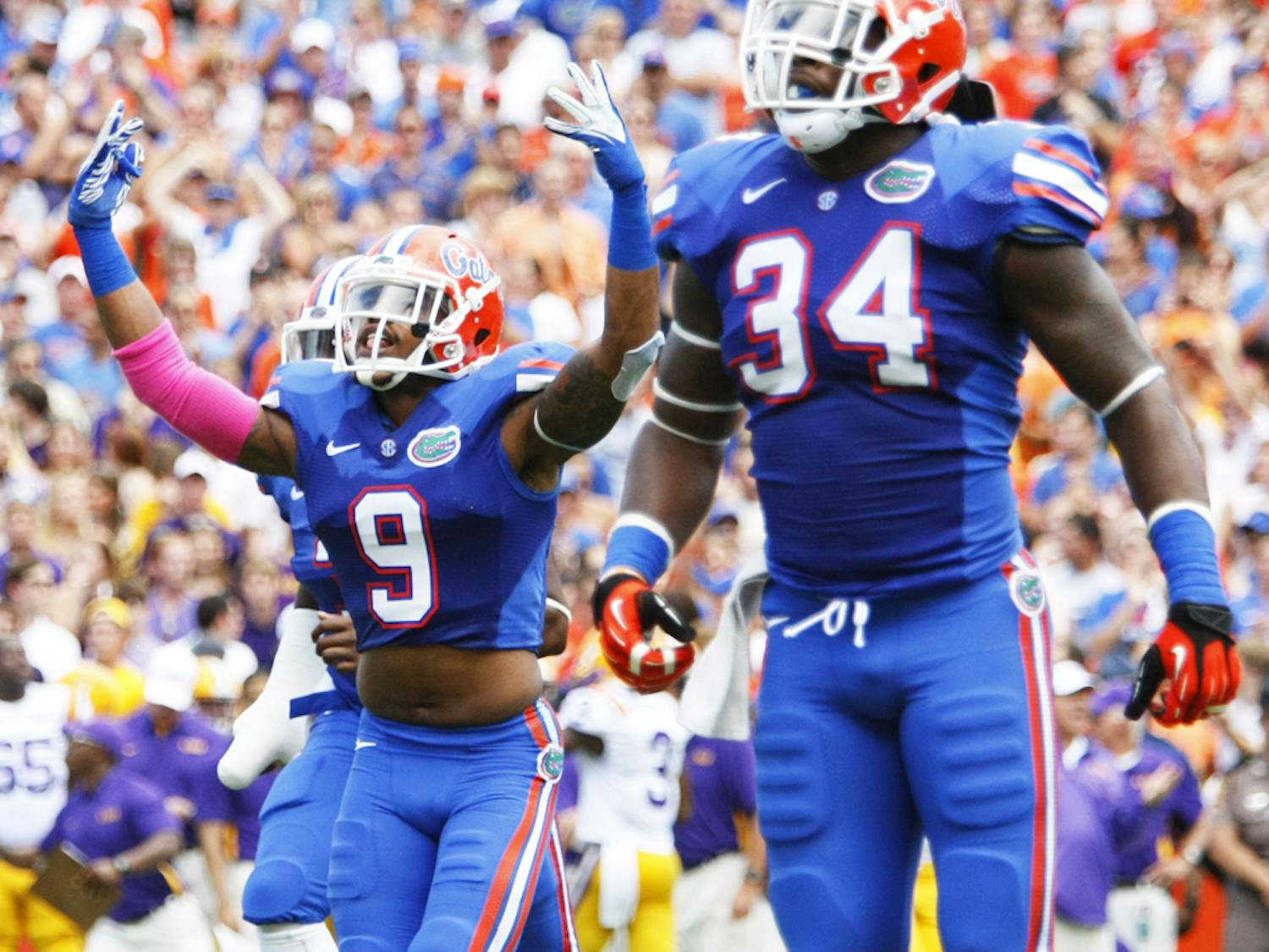 Senior safety Josh Evans (9) and redshirt senior linebacker Lerentee McCray (34) celebrate after making a stop during Florida's 14-6 win against LSU on Oct. 6.