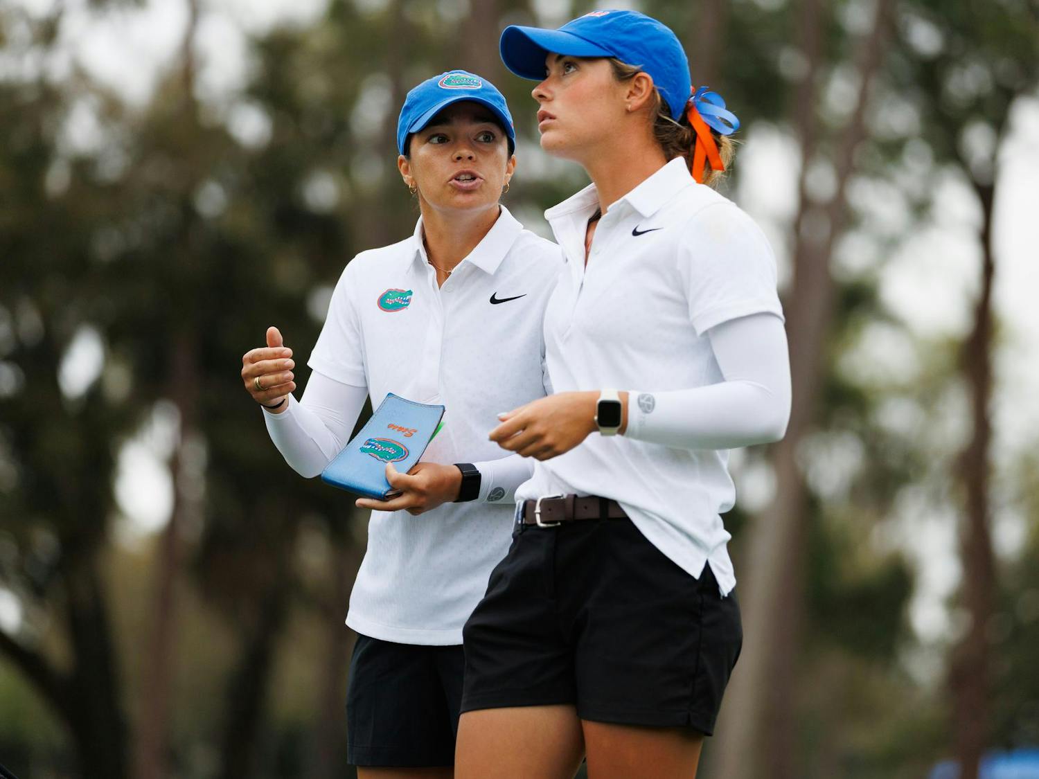 Florida women's golf assistant coach Ashley Sease talks with junior Paula Francisco before tee off during the Gators Invitational golf tournament, Friday, March 6, 2026, in Gainesville, Fla.