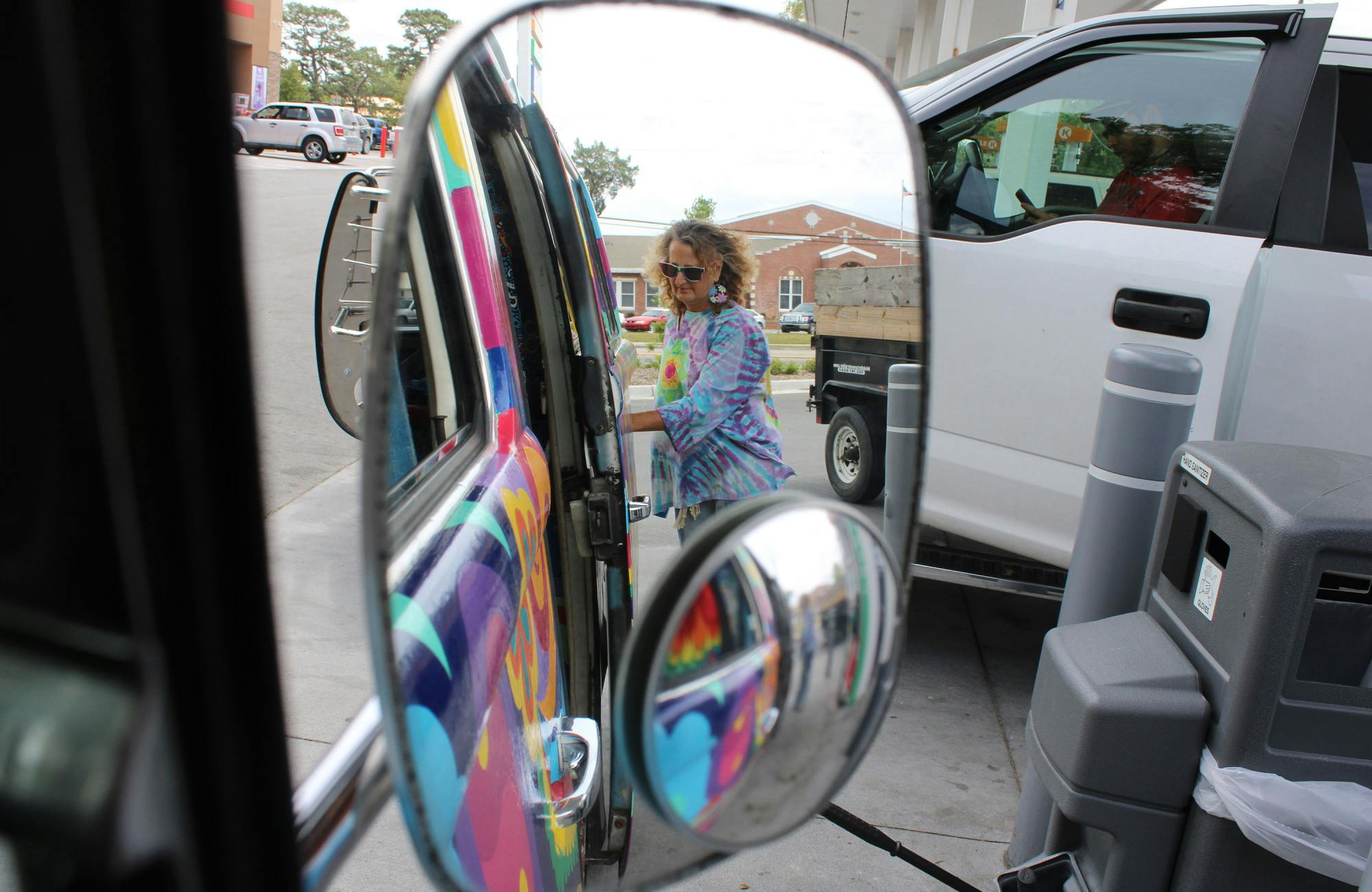 Elaine Hargrove puts gas in her 1978 Volkswagen bus, nicknamed Groovy Gus the Hippie Bus, on Tuesday, April 11, 2023. 
