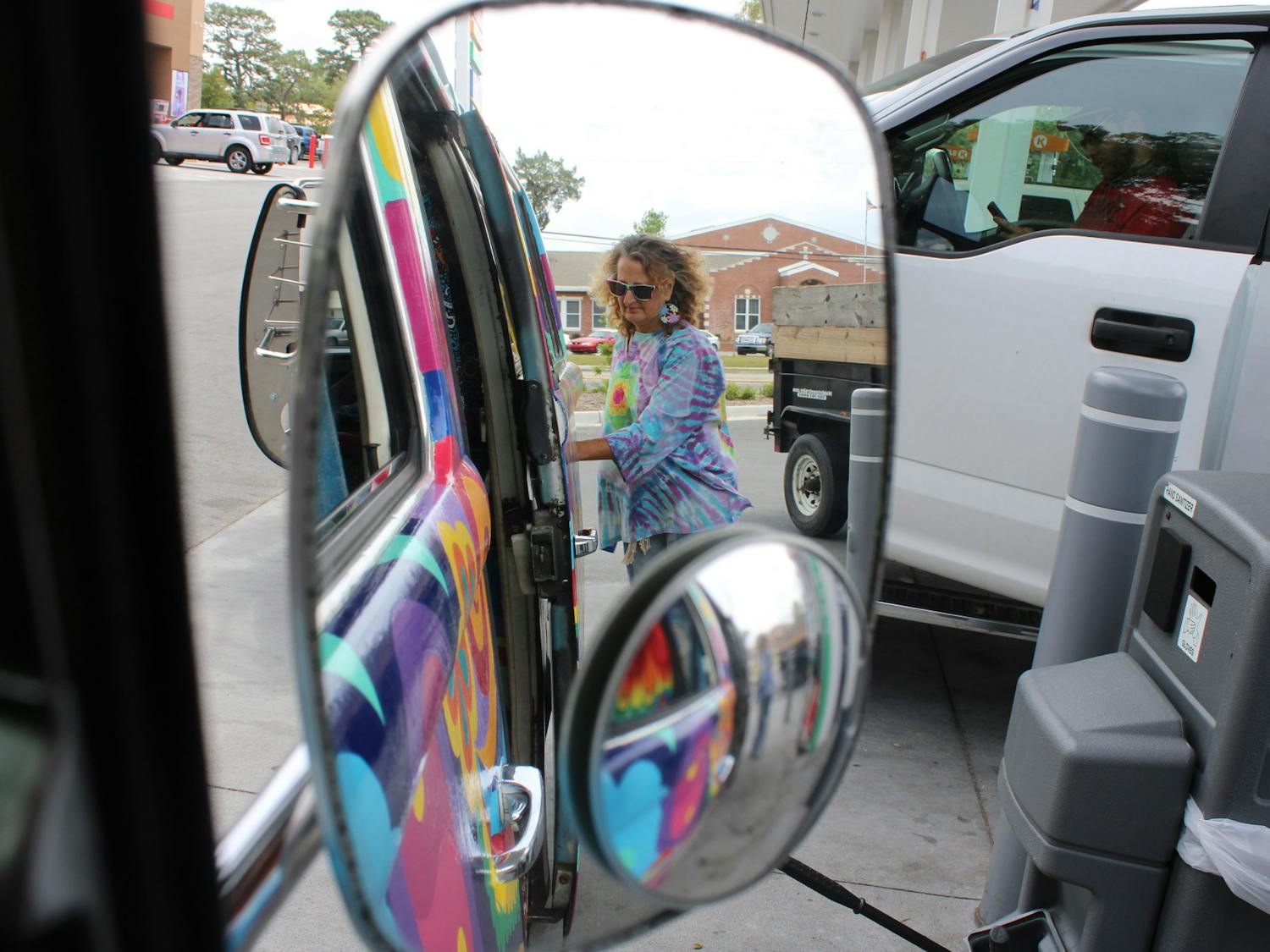 Elaine Hargrove puts gas in her 1978 Volkswagen bus, nicknamed Groovy Gus the Hippie Bus, on Tuesday, April 11, 2023. 