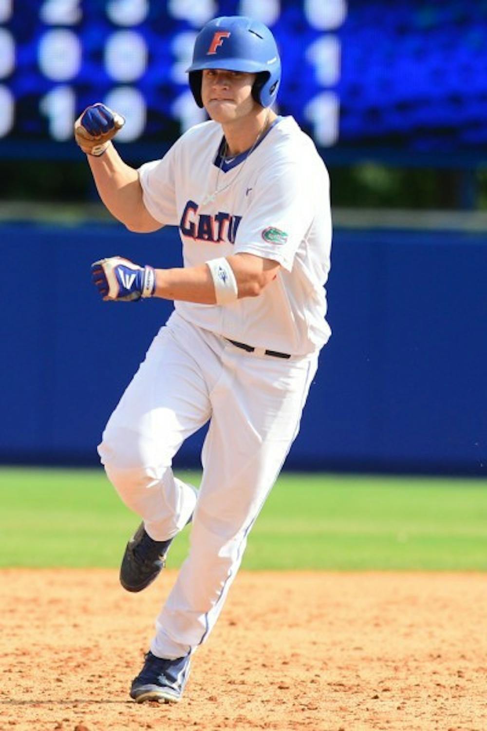 <p>Florida outfielder Daniel Pigott pumps his fist as he rounds second base following his three-run home run in the sixth inning of Sunday’s win.</p>