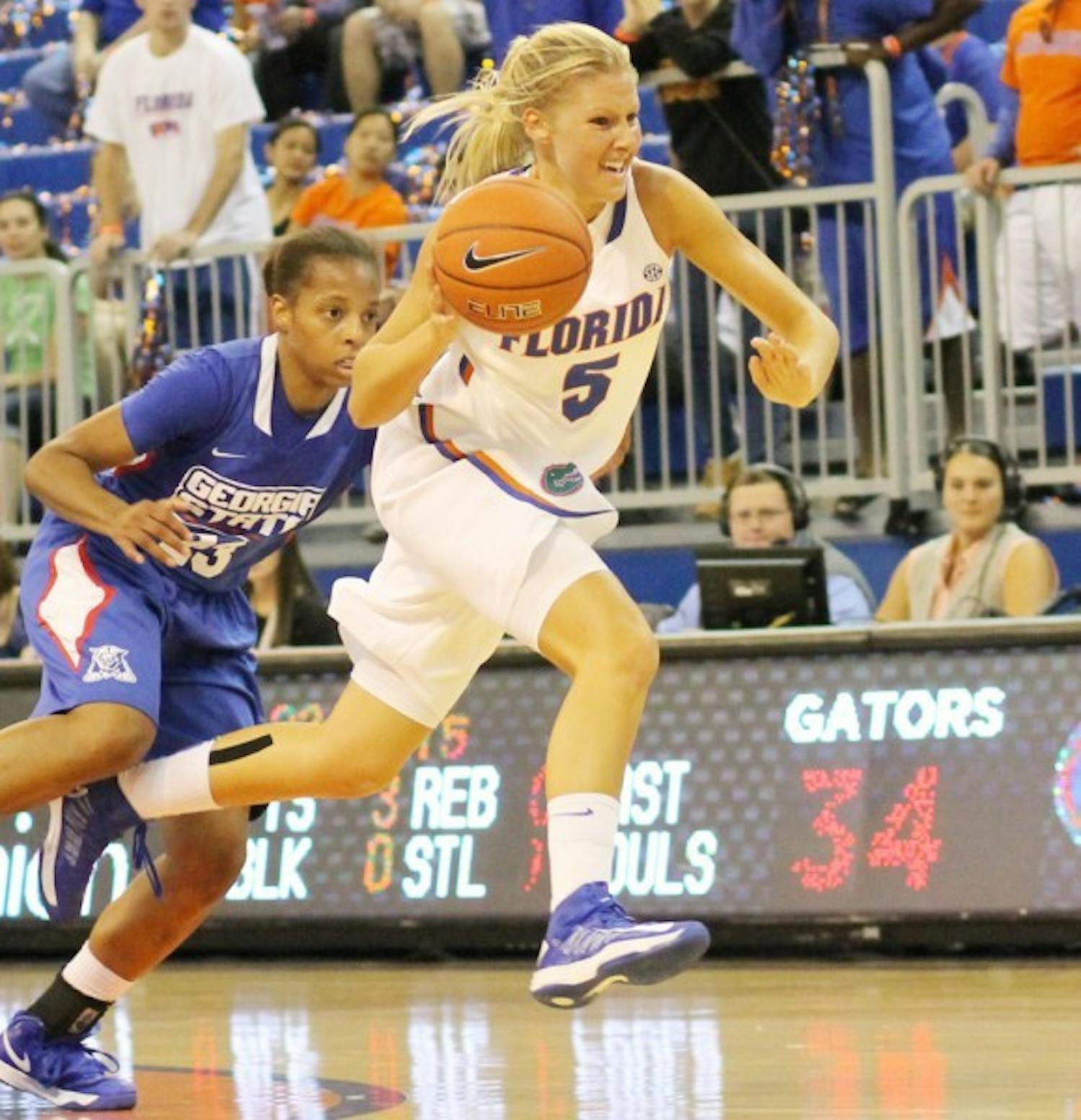 Guard Chandler Cooper (5) dribbles past Georgia State guard Ashley Watson during the Gators’ 84-65 win on Nov. 11 in the O’Connell Center. After seeing time in only three games for the Gators in 2012-13 because of a left foot injury, Cooper has decided to transfer to Lipscomb University.&nbsp;