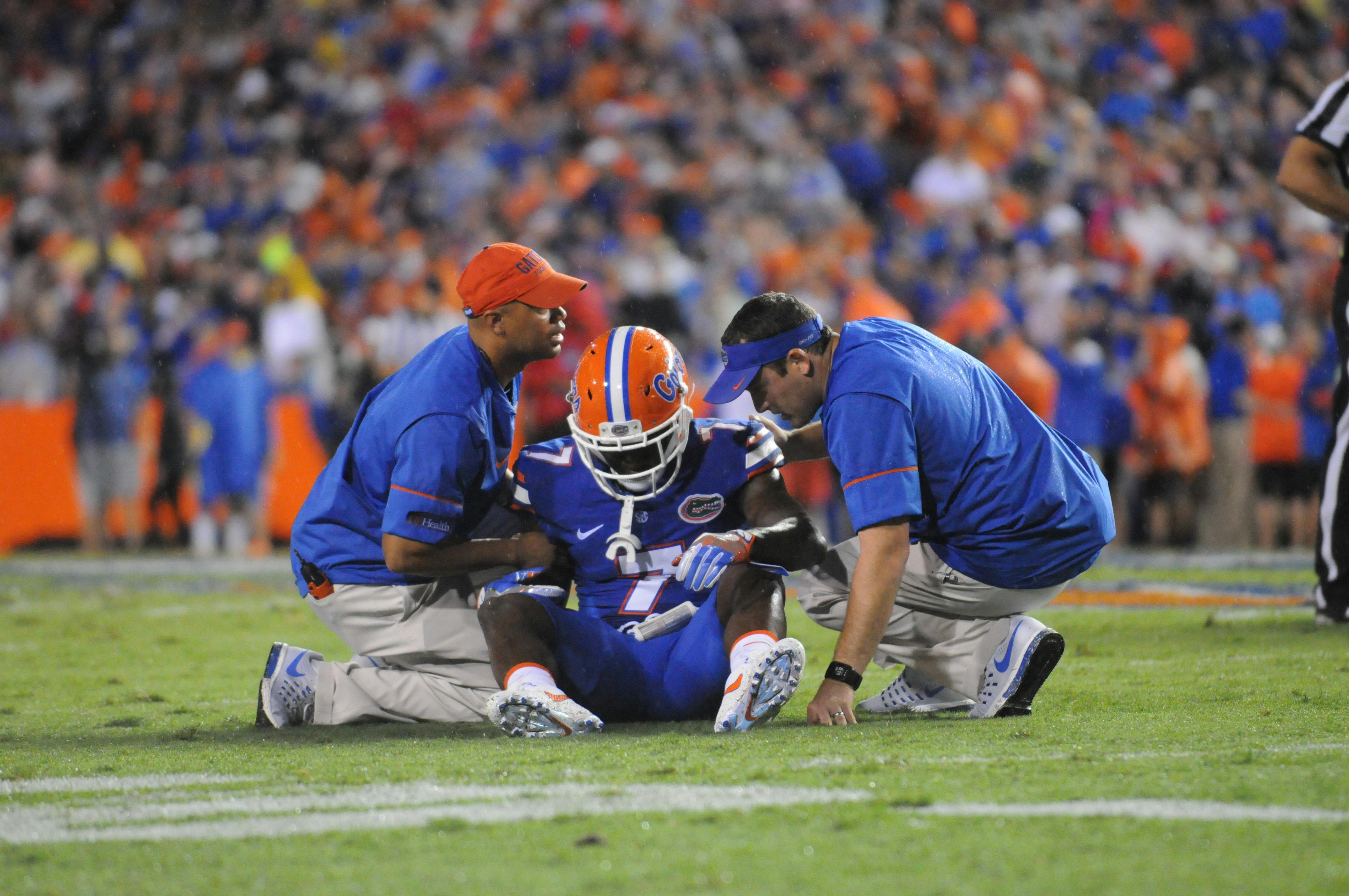 Duke Dawson talks with trainers after a play during Florida's 24-7 win over Massachusetts on Sept. 3, 2016, at Ben Hill Griffin Stadium.