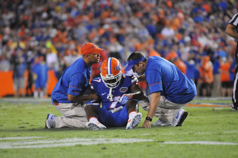 <p>Duke Dawson talks with trainers after a play during Florida's 24-7 win over Massachusetts on Sept. 3, 2016, at Ben Hill Griffin Stadium.</p>
