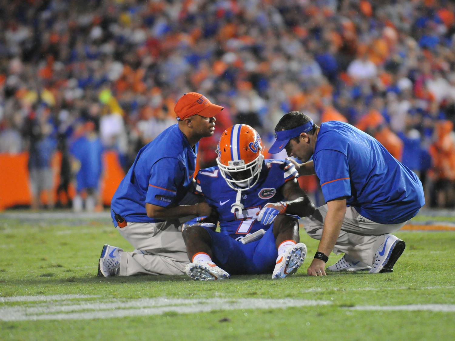 Duke Dawson talks with trainers after a play during Florida's 24-7 win over Massachusetts on Sept. 3, 2016, at Ben Hill Griffin Stadium.