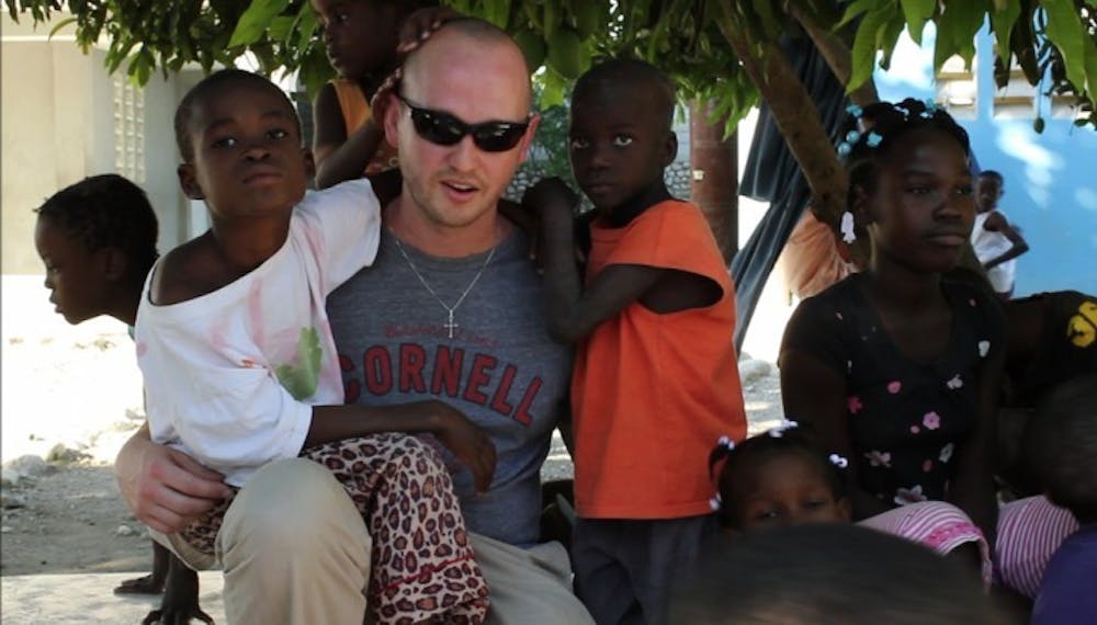 <p>UF alumnus Barrett Keene visits with orphaned children in Croix-des-Bouquet, Haiti, at one of the 15 orphanages supported by The Global Orphan Project.</p>