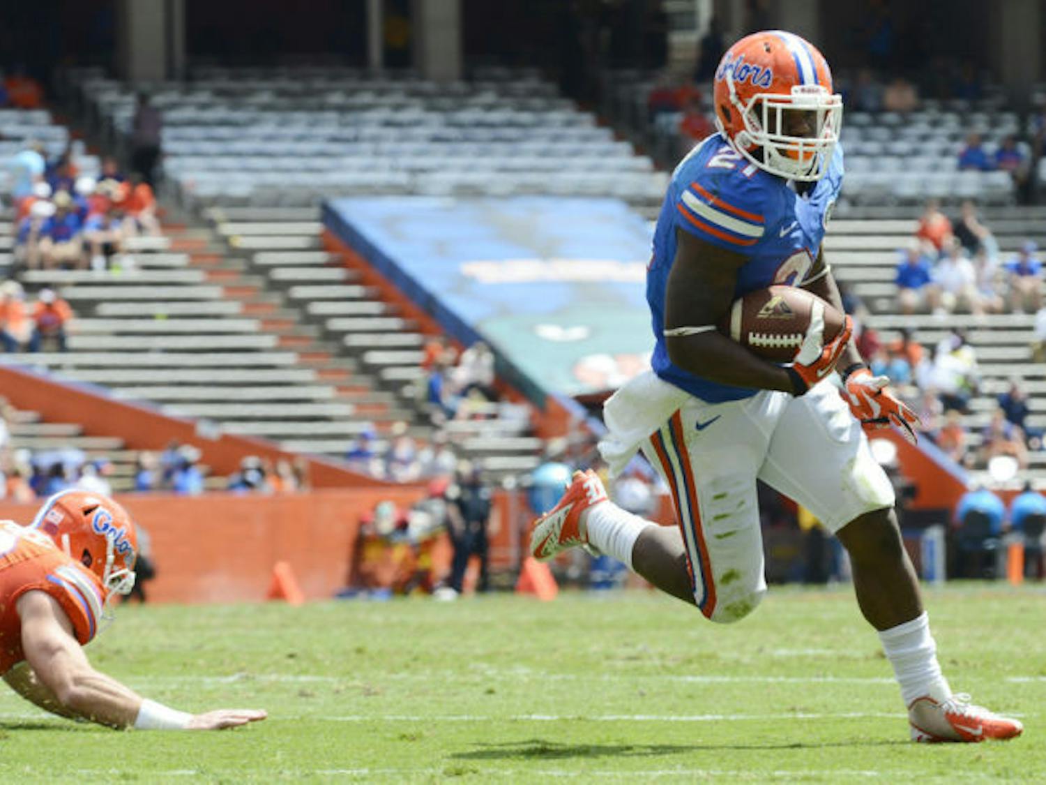 Freshman running back Kelvin Taylor (21) scores a touchdown during drills at the Orange and Blue Debut on Saturday at Ben Hill Griffin Stadium. 