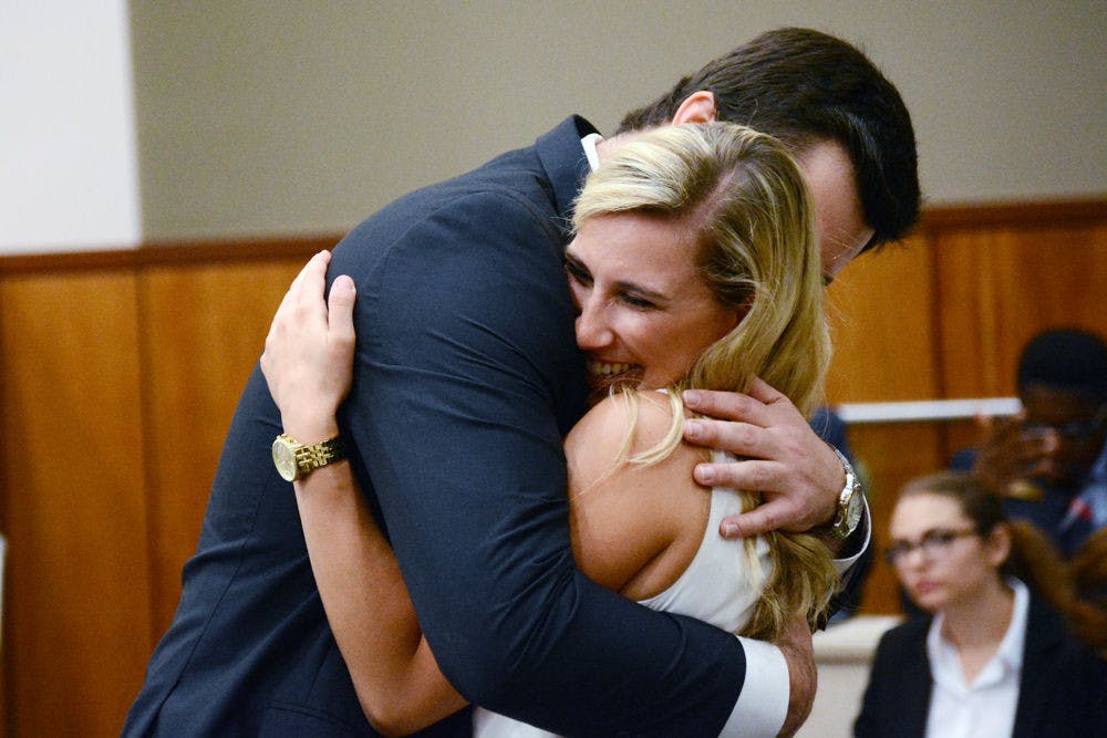 <p>Sens. Davis Bean and Leah Miller embrace after they are elected UF Student Senate President and President Pro-tempore, respectively, at Tuesday night's UF Student Senate meeting.</p>