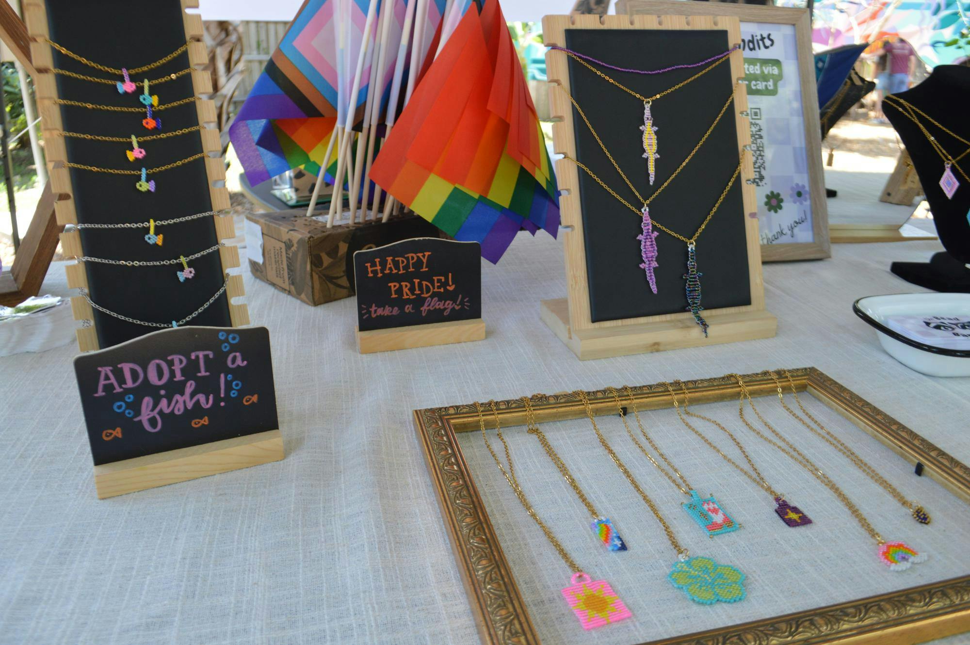 The Bead Bandits shop gives away pride flags alongside its jewelry at the "Queer Makers Market" at 4th Avenue Food Park in Gainesville, Fla., on Sunday, June 7, 2026. 
