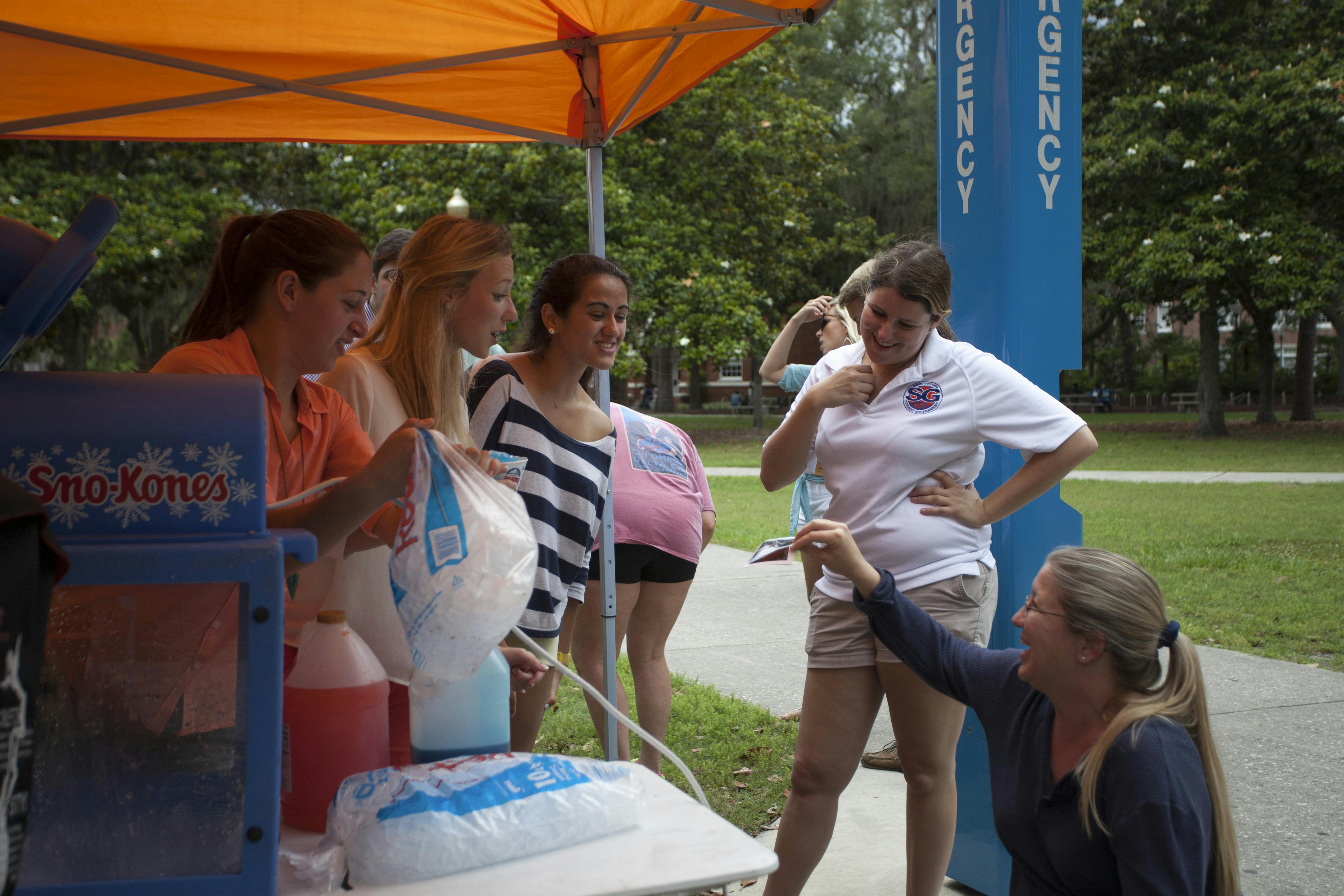 Public relations major Carolyn Hand, 38, shows Student Government President Christina Bonarrigo a sonogram of her expectant baby.