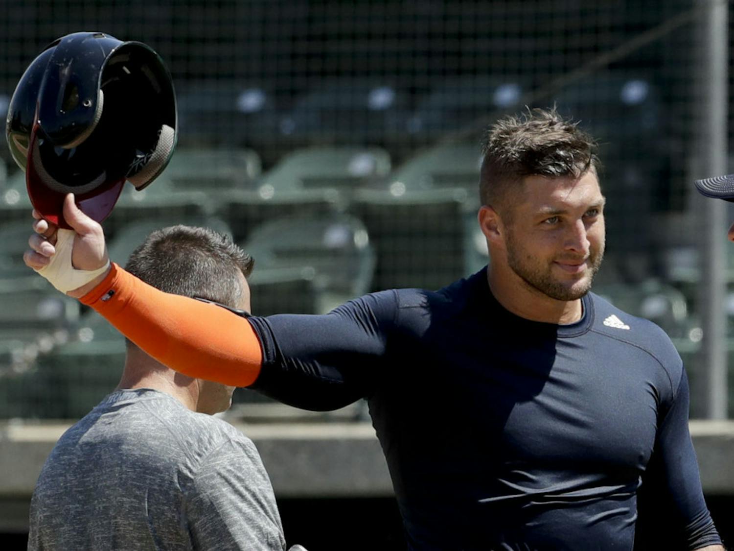 Former NFL quarterback, Tim Tebow finishes his work out for baseball scouts and the media during a showcase on the campus of the University of Southern California, Tuesday, Aug. 30, 2016 in Los Angeles. The Heisman Trophy winner works out for a big gathering of scouts on USC's campus in an attempt to start a career in a sport he hasn't played regularly since high school. (AP Photo/Chris Carlson)