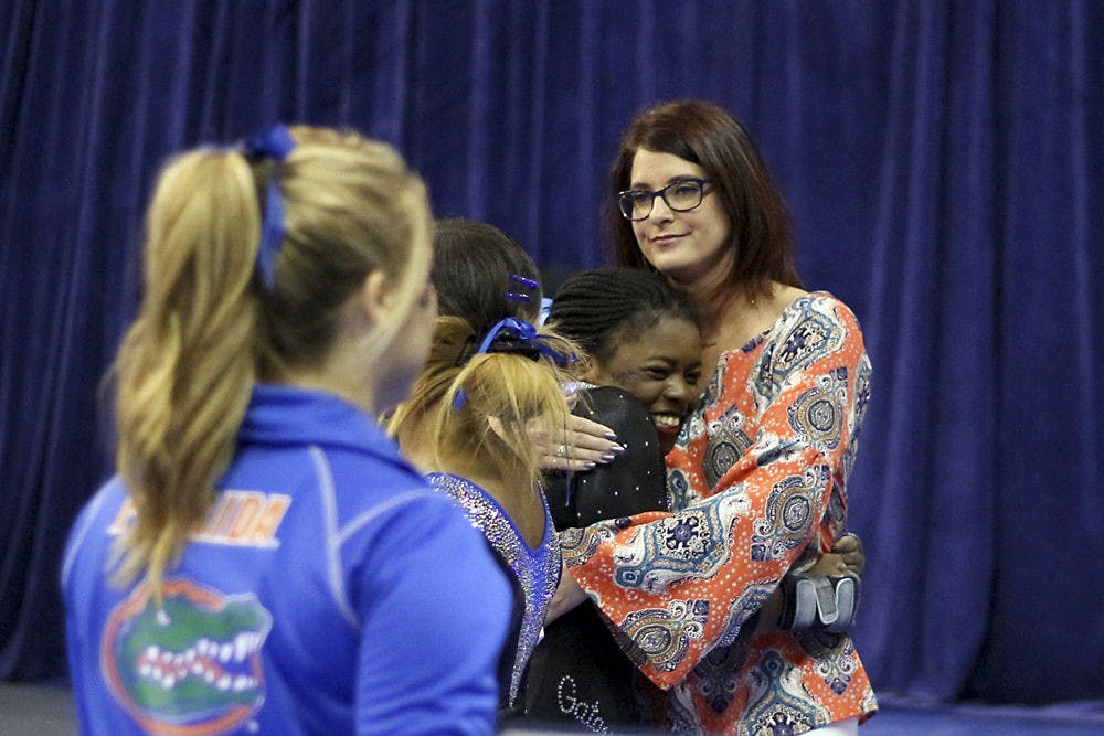 <p>Alicia Boren hugs coach Jenny Rowland during Florida's win over North Carolina on March 11, 2016, in the O'Connell Center.</p>