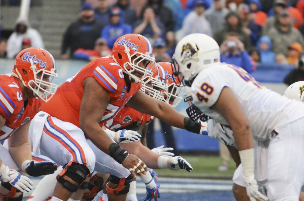 <p>Max Garcia snaps the ball during Florida's 28-20 win against East Carolina in the Birmingham Bowl on Saturday at Legion Field.</p>