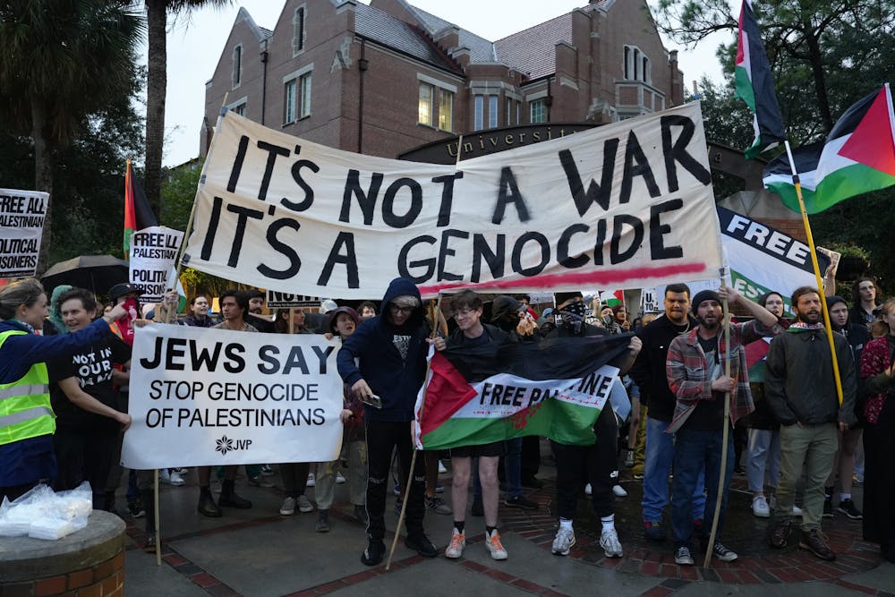 <p>Around 60 protestors gather on the corner of University Avenue and 13th Street in support of Palestine on Thursday, Nov. 16, 2023. </p>