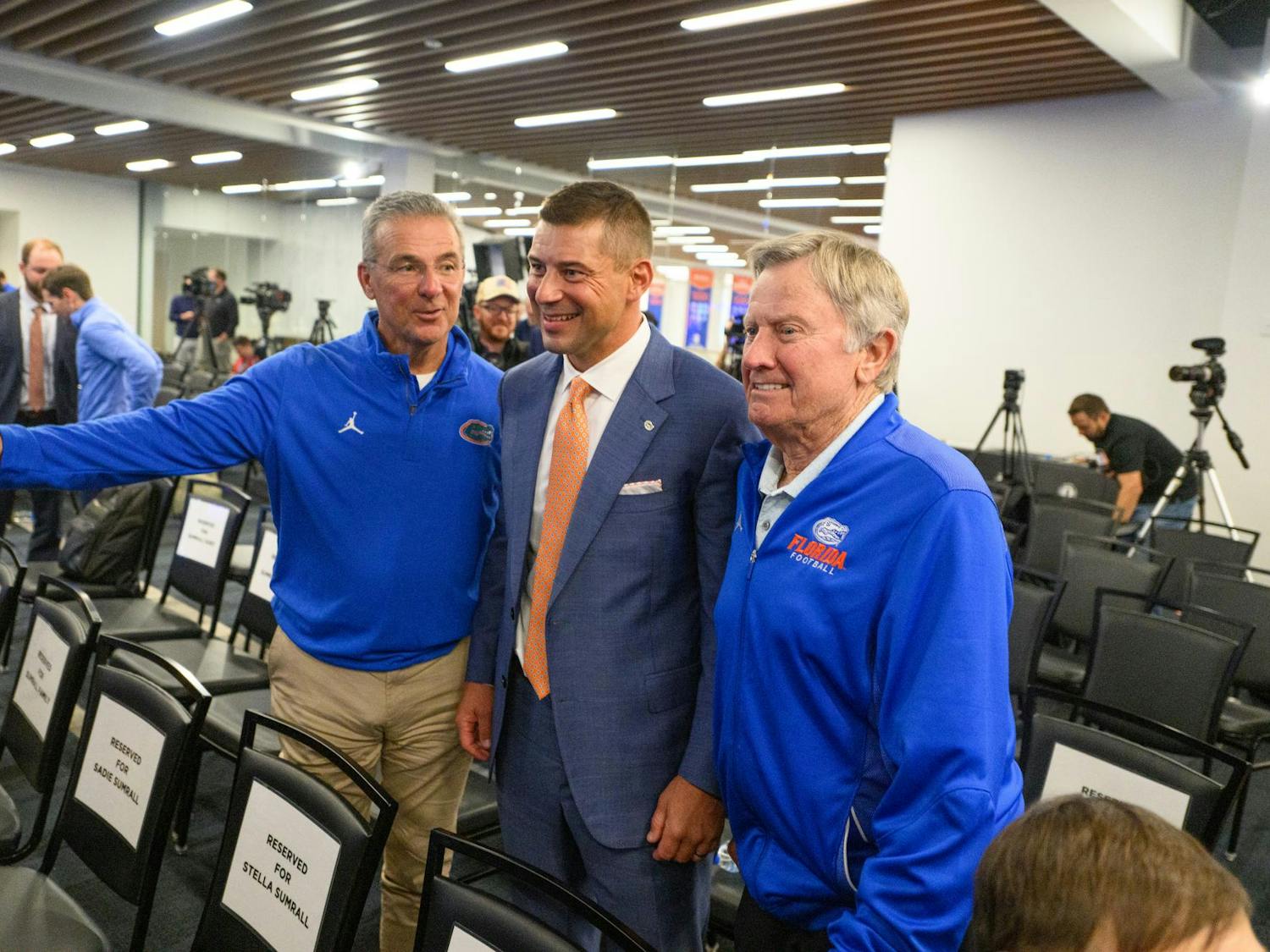 Former Florida head coaches Urban Meyer (left) and Steve Spurrier (right) pose for a photo with head coach Jon Sumrall (center) after his introductory press conference at Heavener Football Training Center in Gainesville, Fla., Monday, Dec. 1, 2025.