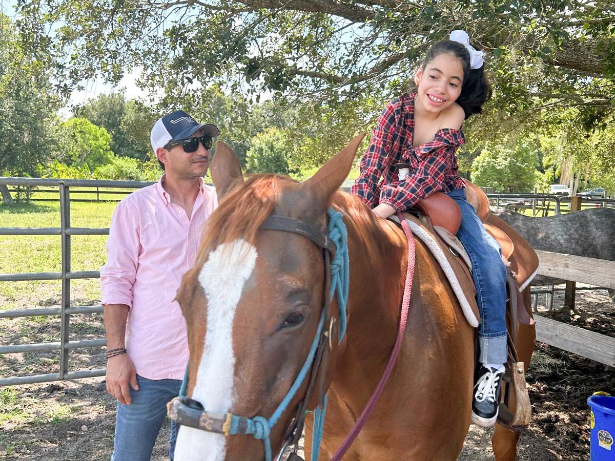 A girl rides a horse as a part of equine therapy in Lake Wales, Fla. on June 8, 2024.